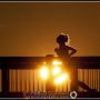 #Telephoto shot of a #jogger running past the setting #Sun in #Bellingham, WA: #photojournalism #photography #sunset